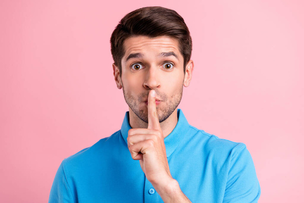 Photo of young serious brown haired male showing silence gesture shut up isolated on pink color background - Φωτογραφία, εικόνα