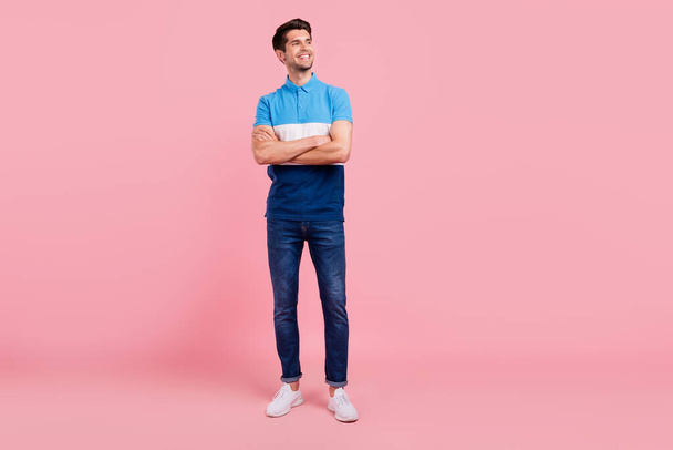 Full length photo of nice brunet millennial guy stand look empty space wear polo jeans sneakers isolated on pink background - Fotó, kép