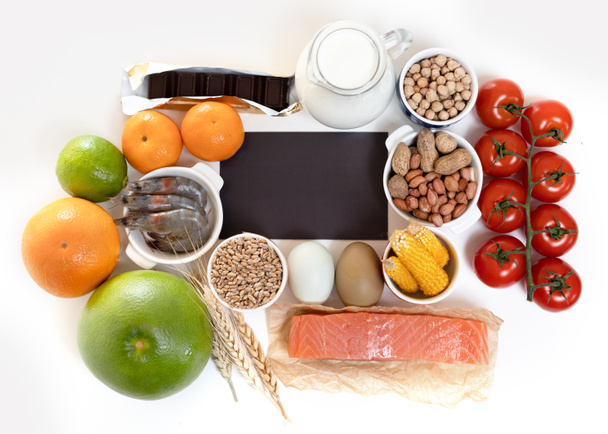 Elimination diet concept. Food allergens on plate - fish, seafood, dairy, peanuts, tree nuts, eggs, chocolate, wheat, soy, citrus fruits. - Photo, Image