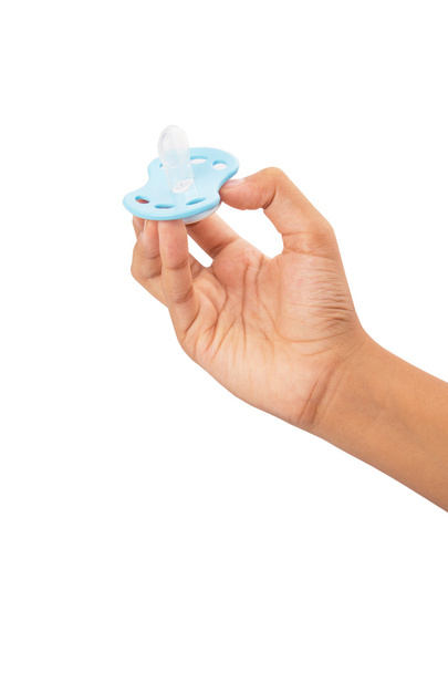 Female Hand Holding Blue Pacifier - Foto, immagini