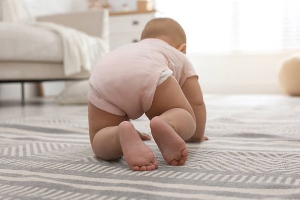 Cute baby crawling at home, focus on legs - Fotó, kép