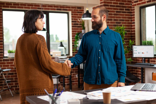 Businesspeople shaking hands during business meeting in startup office - Photo, Image