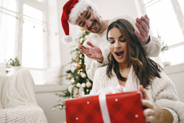 Young cheerful couple in love with present for Christmas - Foto, immagini