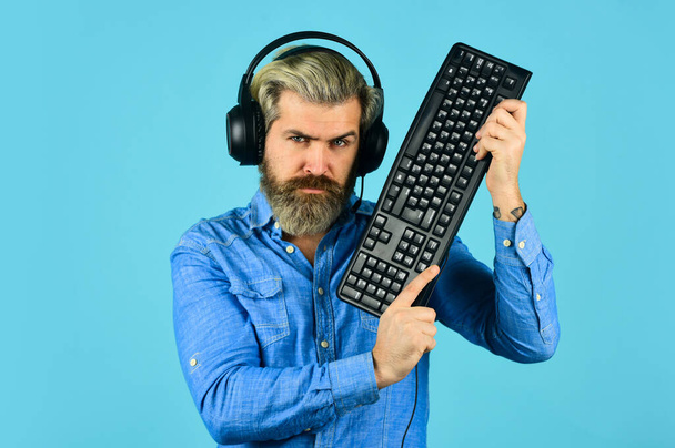 Run any modern game. Gaming PC build guide. Graphics settings pushed to limit. Gaming addiction. Online gaming. Modern leisure. Play computer games. Man bearded hipster gamer headphones and keyboard - Fotó, kép