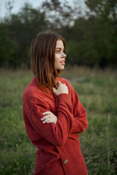 pretty woman in red sweater outdoors walk leisure - Foto, afbeelding