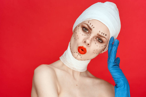 female patient Red lips plastic surgery operation bare shoulders red background - Fotó, kép