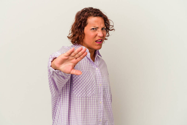 Middle age latin woman isolated on white background rejecting someone showing a gesture of disgust. - Photo, Image