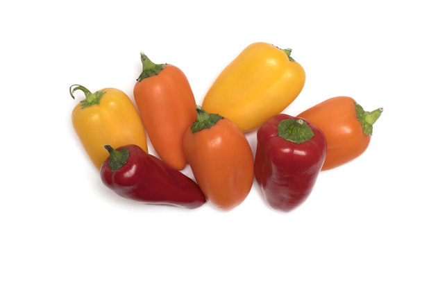 various different colored snack bell pepper pods in yellow orange and red side by side isolated on white background - Φωτογραφία, εικόνα