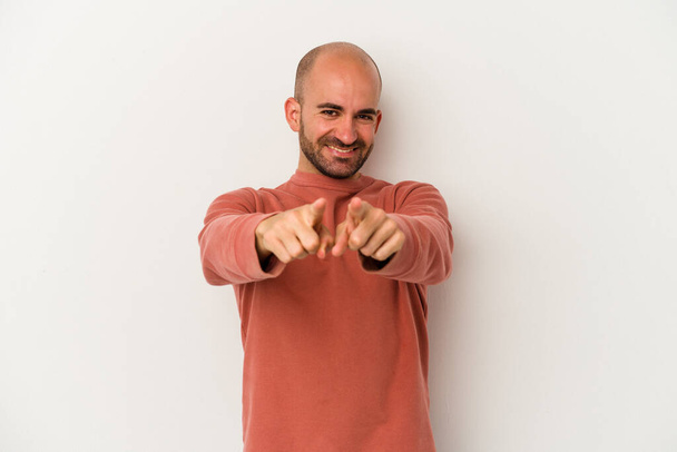 Young bald man isolated on white background pointing to front with fingers. - Photo, Image