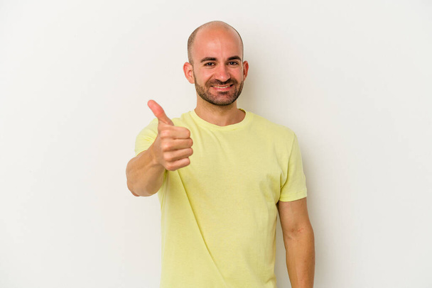 Young bald man isolated on white background smiling and raising thumb up - 写真・画像