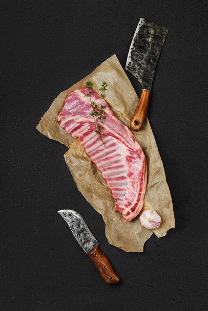 Top view of raw fresh lamb ribs, uncut on wrapping paper - Фото, зображення