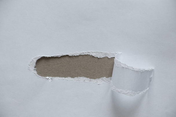 white torn paper with a hole in the middle, torn paper, space for text, white paper background - Photo, Image