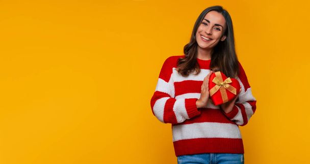Banner photo of gorgeous happy brunette woman with gift box in the shape of a heart in hands from her beloved in some holiday - Foto, afbeelding