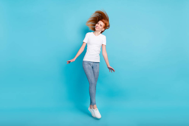 Full body photo of young attractive girl happy positive smile jump up isolated over blue color background - Φωτογραφία, εικόνα