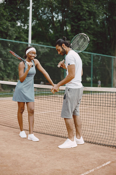 Two tennis players talking on a tennis court before the match - Fotó, kép