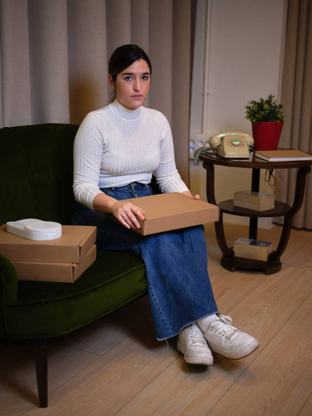 enterprising woman sitting showing off her new product - Фото, зображення