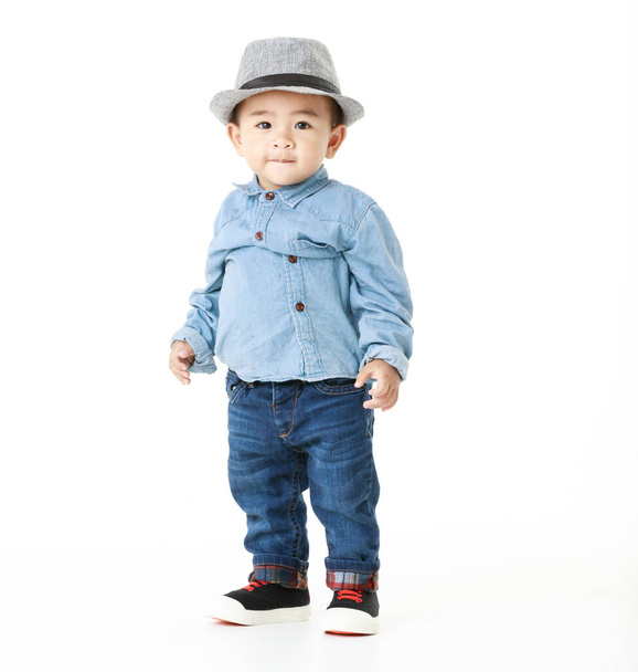 Lovely portrait of cute Asian little boy smiling on smart hat and handsome outfit with happy to play outdoors. Attractive innocent kid looks healthy, cheerfully enjoy walking as childhood lifestyle. - Foto, Imagem