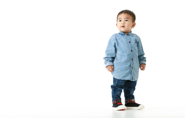 Lovely and handsome little Asian boy on long sleeved shirt for smart outfit standing with confident and sparkling eyes, chin up, and smile for hopeful expectation of beautiful childhood lifestyle. - Photo, Image