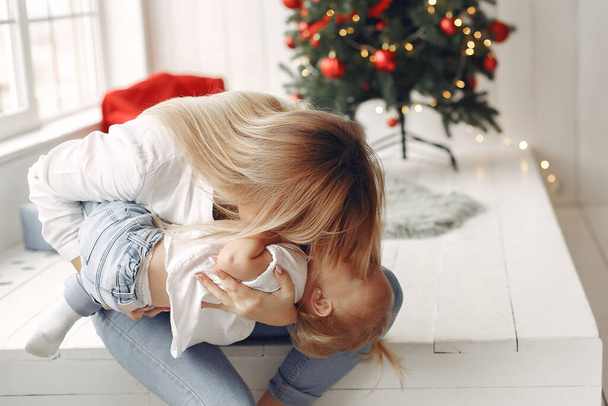 Mother and little daughter spend time together in a New Years setting. - 写真・画像