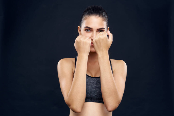 woman athlete fitness workout exercise close-up black background - Valokuva, kuva