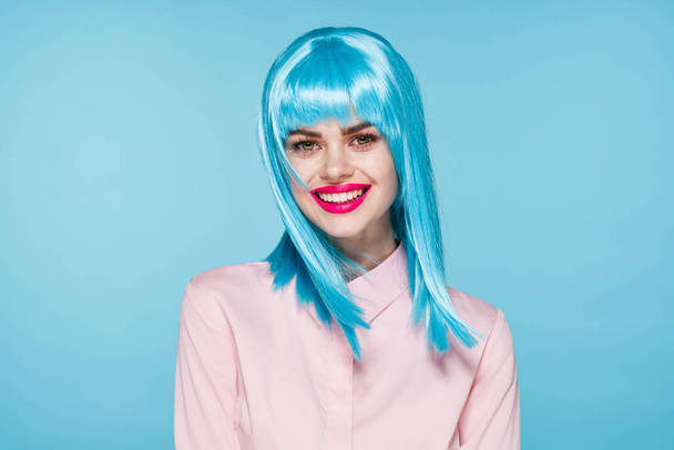 cheerful glamorous woman in pink shirt blue wig makeup model - 写真・画像