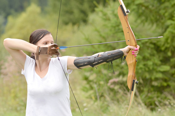 Young woman training with the bow - Фото, зображення