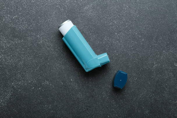 Asthma inhaler on dark background - 写真・画像