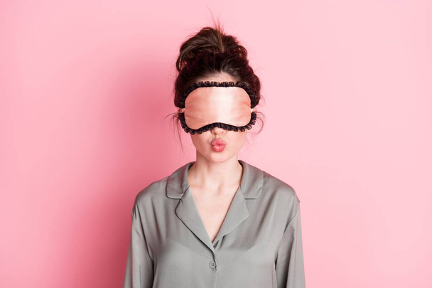 Photo of nice hairdo charming person wear eye sleep mask kiss lips isolated on pink color background - Photo, image