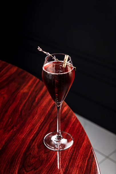 Kir royal low abv cocktail in a flute glass garnished with lavender - Fotó, kép