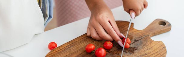 Cropped view of african american woman and kid cutting cherry tomatoes in kitchen, banner  - Fotografie, Obrázek