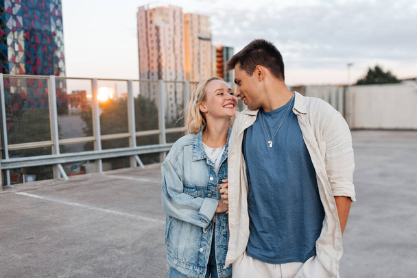 happy young couple on roof top city parking - Foto, imagen