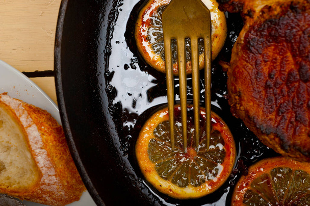 pork chop seared on iron skillet with lemon and spices seasoning - Photo, Image