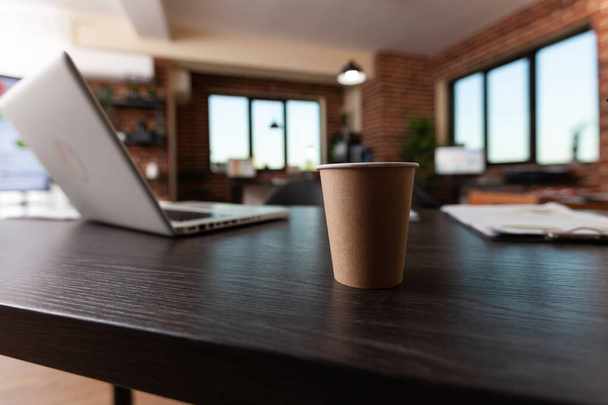 Крупним планом одноразова чашка кави на дерев'яному столі
 - Фото, зображення