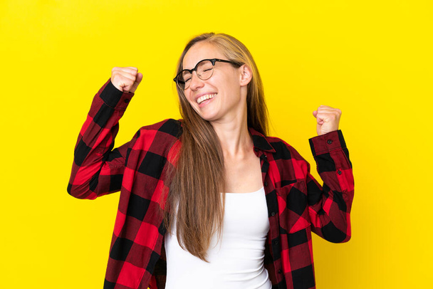 Young English woman isolated on yellow background celebrating a victory - Photo, Image