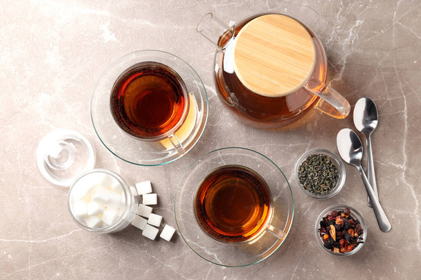 Concept of hot drink with tea on beige textured background - Fotografie, Obrázek