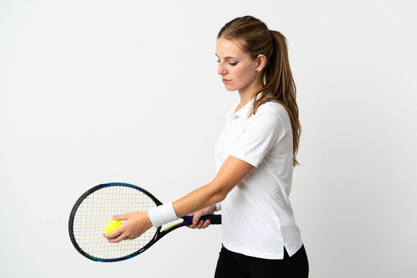 Young caucasian woman isolated on white background playing tennis - 写真・画像