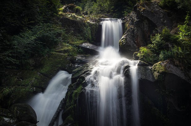 Idyllic waterfall falls into a dark gorge in the Black Forest - Photo, image