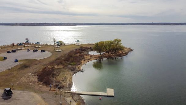 Aerial view Murrell Park with float fishing dock, high water boat ramp and row of tent-only campsites along the lakeshore with views of the water at Grapevine Lake, Texas, USA. - Photo, Image