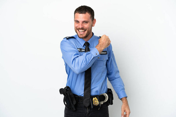 Young police Brazilian man isolated  on white background celebrating a victory - Photo, Image