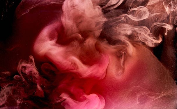 Pink smoke on black ink background, colorful fog, abstract swirling touch ocean sea, acrylic paint pigment underwater - Zdjęcie, obraz