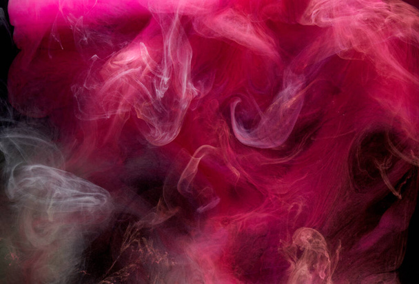 Pink smoke on black ink background, colorful fog, abstract swirling touch ocean sea, acrylic paint pigment underwater - Фото, зображення