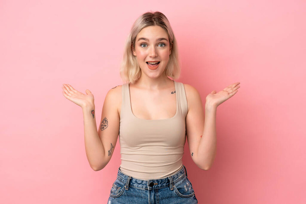 Young caucasian woman isolated on pink background with shocked facial expression - Photo, Image