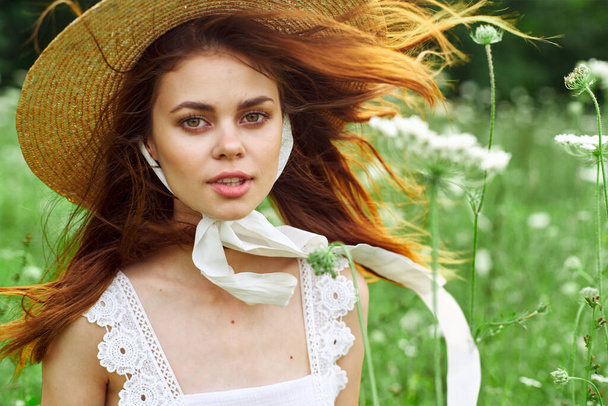 pretty woman with hat nature field flowers fresh air - Foto, Imagen