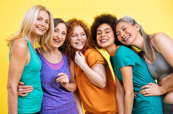 Group of women with different body, age, and ethnicity making sport. Female models wearing sport outfits having fun at the gym. Concept about body positivity, self acceptance and lifestyle - Photo, Image