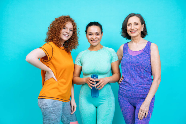 group of women with different body, age, and ethnicity making sport. Female models wearing sport outfits having fun at the gym. Concept about body positivity, self acceptance and lifestyle - Photo, image