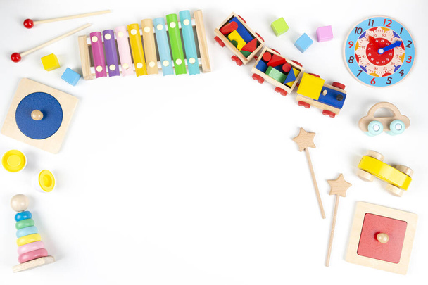 Colorful wooden educational and musical toys for baby kids on white background. Top view, flat lay frame - Photo, Image