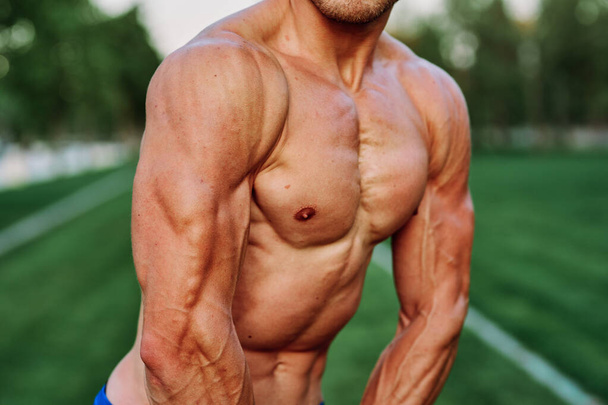 man with pumped up muscular body outdoors health workout - Φωτογραφία, εικόνα