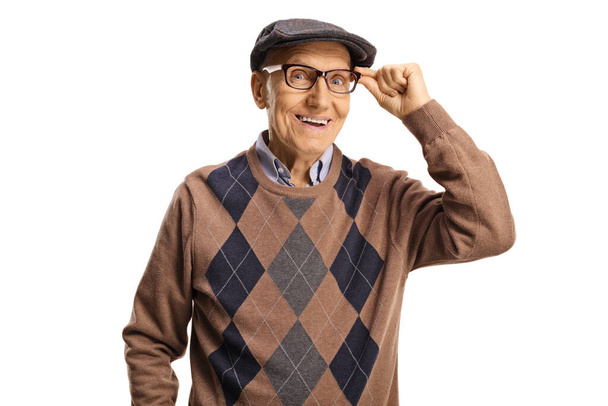 Cheerful elderly man holding his glasses isolated on white background - Foto, afbeelding