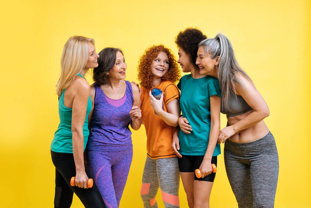 Group of women with different body, age, and ethnicity making sport. Female models wearing sport outfits having fun at the gym. Concept about body positivity, self acceptance and lifestyle - Zdjęcie, obraz