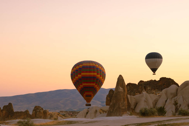 Hot Air Balloons. Fairy Chimneys or Hoodoos with Hot Air Balloons in Cappadocia. Cappadocia background photo. - Fotoğraf, Görsel